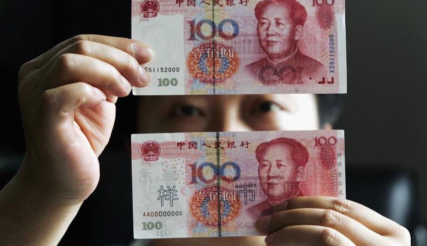 A Man Holding Two 100-Yuan Notes In Front of His Head | Choose-Forex