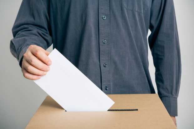 A Man Putting His Vote in a Ballot